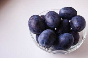 fresh plums in a bowl