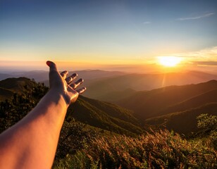 sunrise over mountain range hand reach