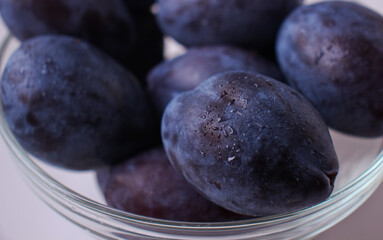 Blue plums in bowl close-up