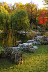 A pond in a city park at sunset in autumn.