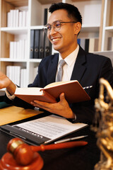 Obraz premium A man in a suit is sitting at a desk with a book titled 