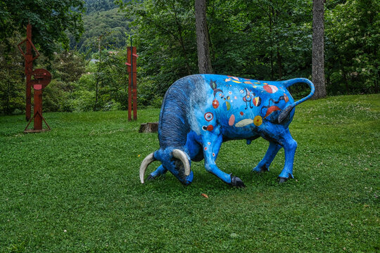 Busteni, Romania - June 24, 2024: Colorful Blue Bull Sculpture in Cantacuzino Castle Park