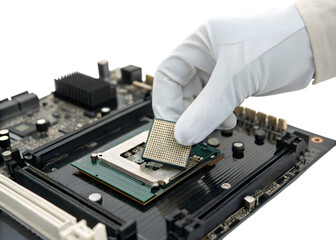 Gloved hand installing a processor chip into a motherboard socket during computer assembly
