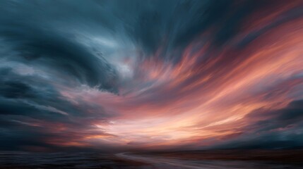 Obraz premium Dramatic sunset sky with swirling clouds over a desolate landscape with a winding path