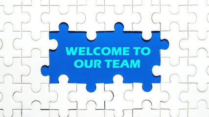 Fototapeta premium The concept of the words Welcome To Our Team in the middle of the puzzle. The background is light blue.