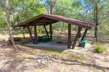 Photograph of an old semi abandoned wooden picnic shelter located in a forest in the Blue Mountains, NSW, Australia.