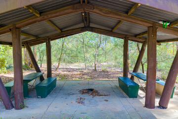 Photograph of an old semi abandoned wooden picnic shelter located in a forest in the Blue Mountains, NSW, Australia.