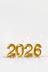Golden 2026 numbers on white festive background. Elegant celebration concept symbolizing the upcoming year, perfect for holiday greetings, calendars, and festive marketing materials.