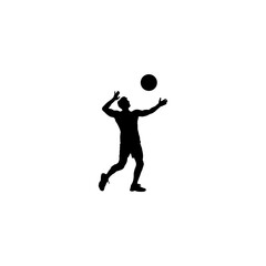 Silhouette of a male volleyball player in action hitting the ball during a game
