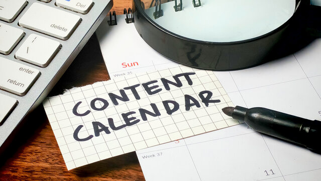 Digital Marketing Strategy: Planning a Content Calendar on Desk with Calendar and Magnifying Glass