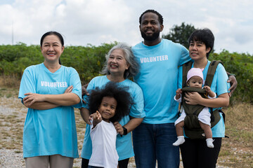 Family with daughter walking on field on wind farm. Happy Family and daughter playing at the Wind turbines generating electricity. Family time together.