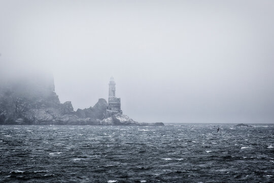 Aniva lighthouse in the fog. Sakhalin. Russia