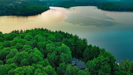 Morning lake in the mountains surrounded by forest and trees