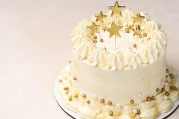 Delicious cake with Christmas decor on beige table, closeup. Space for text