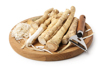 Whole and grated horseradish roots near peeler isolated on white