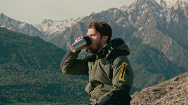 Traveler man drinking hot coffee on mountain top with copy space concept of freedom mindfulness travel adventure outdoor lifestyle calm morning energy relaxation and happiness in nature