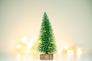Small Festive Fir Tree Against Defocused Warm Lights