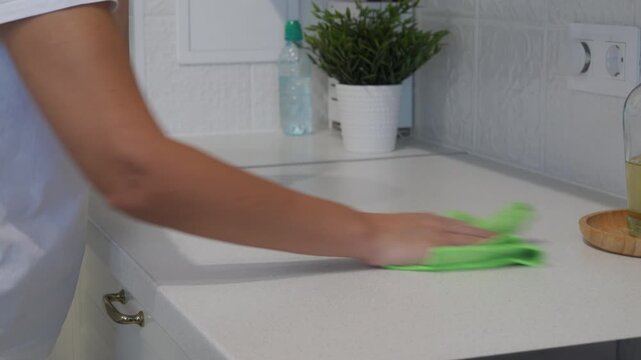A Final Polish: Person Meticulously Wipes Down a Pristine Kitchen Counter.
