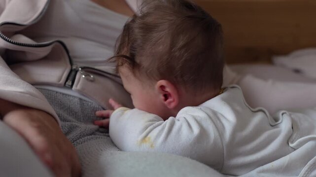 Baby smiling while lying close to parent, warm and affectionate moment expressing connection, security, and early emotional bonding in family home