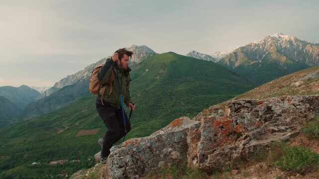 Man hiking through mountain landscape with trekking poles concept of freedom perseverance adventure mindfulness calm journey strength harmony and connection with wild nature