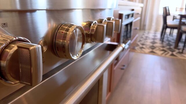 Angled view of stove knobs on panel