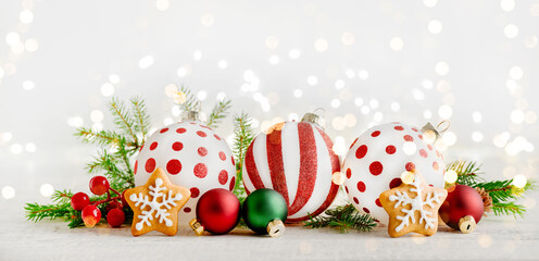 Christmas gingerbread star cookies,Christmas ornament decorations Christmas tree branches, gifts and toys on wooden background with bokeh garland light . Christmas card design element. Banner.