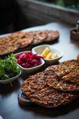 Traditional Turkish lahmacun served with lemon and salad