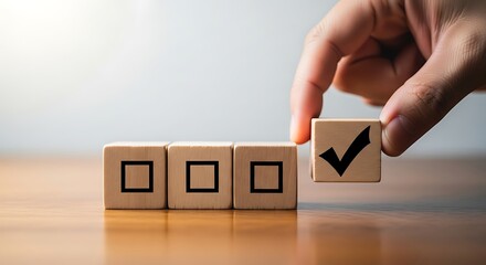 Hand placing a checked block in a row of empty checklist boxes