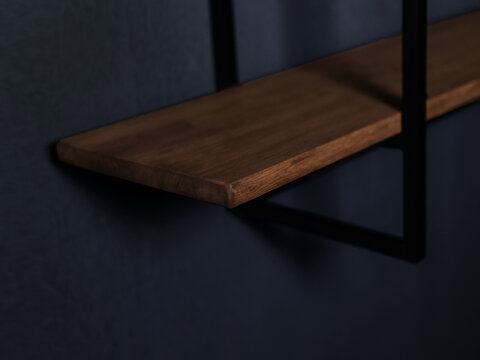 Modern wall shelf made of wood and metal on a dark background, made in loft and garage style