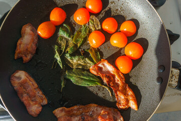 Basic breakfast food ingredients in frying pan