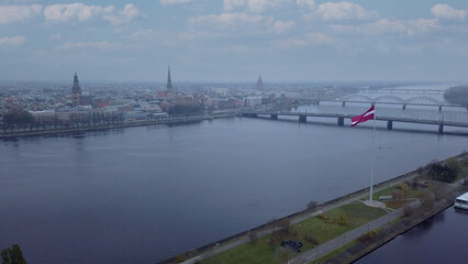 Drone View Of Riga Old Town With Latvian Flag Waving In Foreground Aerial Panorama Of Historic City Center, Daugava River And Urban Skyline On A Outumn Day In Latvia
