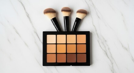 Makeup brushes and contour palette on a white marble surface top view