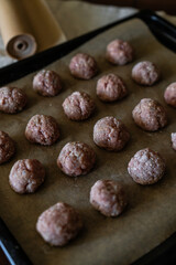 Raw meatballs on baking tray, Baking in oven instead of frying. Healthy eating.