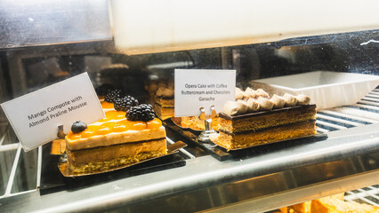 Beautiful cafe display case filled with exquisite pastries, cakes and desserts, ready to eat. Perfect for bakery promotions, cafe menus and food photography.