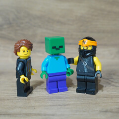 Naklejka premium Lego minifigures of a ninja, a zombie, and a character in a black jacket