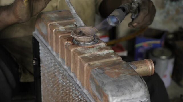 Skilled Craftsman Torching a Metal Box - Precision and Heat