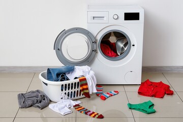 Top view of a laundry basket and a washing machine, chaos around, minimalist background