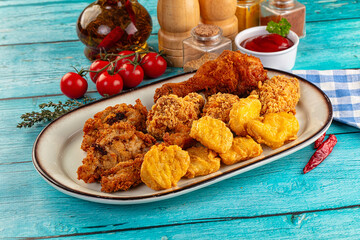 Golden crispy fried chicken mix - wings, drumsticks, nuggets and strips