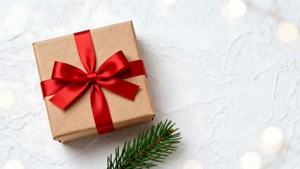 Christmas gift box with red ribbon on white textured background