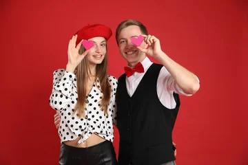 Fotobehang Muziek Cute couple with heart figures on red background. Romantic date  © New Africa