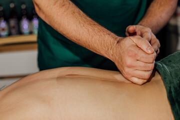 Therapist performing deep tissue massage on client in spa setting