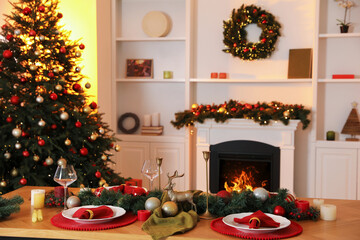 Beautiful room decorated for Christmas with fireplace and dining table