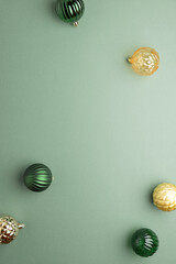 Green and Golden Christmas Ornaments on Green Background in Festive Flat Lay