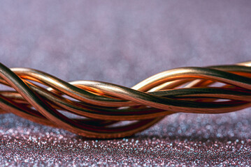Twisted copper wire close-up on glitter sparkle photography backdrop