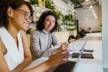 colleagues engaged in collaborative design review surrounded by vibrant cafe atmosphere and notes