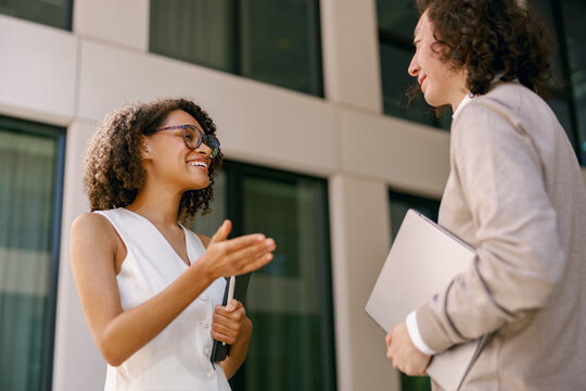 diverse professionals connect, crosscultural business meeting takes place in cityscape environment