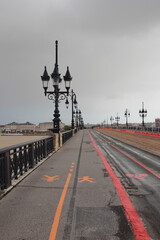 Pedestrian and bike paths on bridge with lanterns. Bordeaux, France