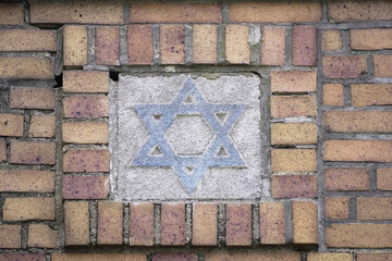 Six pointed Star of David, architectural element signifying the Jewish culture, on crumbling old brick structure