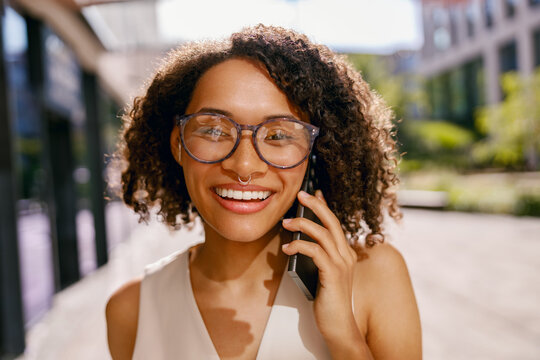 vibrant city mood, closeup image of professional woman enjoying outdoor chat amidst lively city