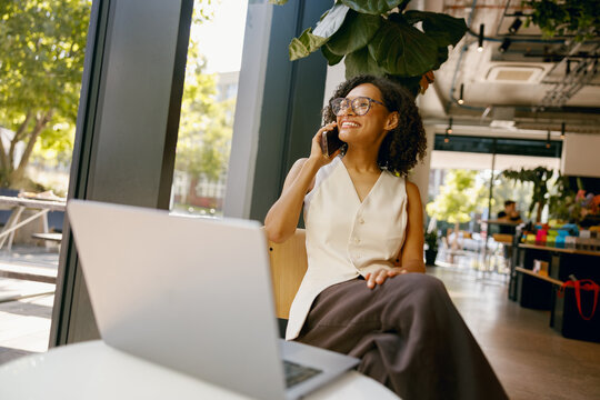 businesswoman multitasking remotely, professional woman managing calls and tasks at home office